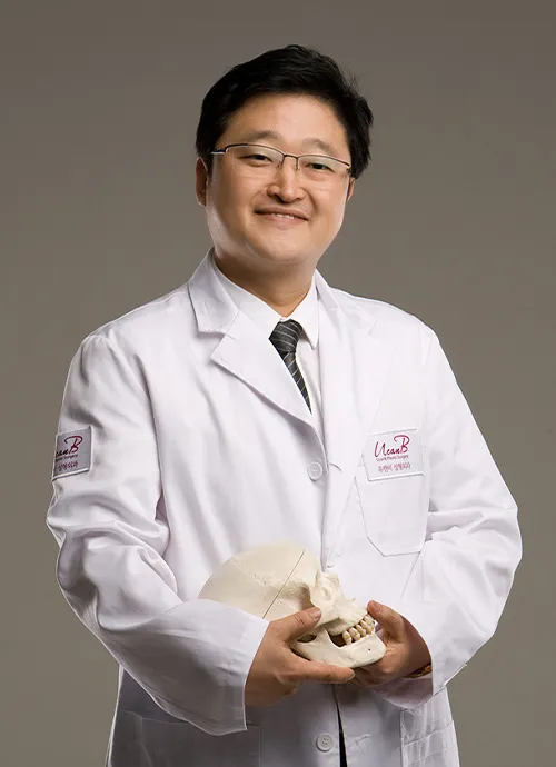 Dr. Kim Jun-ho, Chief Director of UcanB, in a white coat holding a skull model