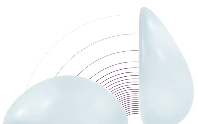 Two teardrop-shaped breast implants on a white background